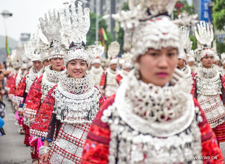 Women in traditional costumes attend a parade during the Yang'esha Cultural Festival in Jianhe County, southwest China's Guizhou Province, July 21, 2015. 