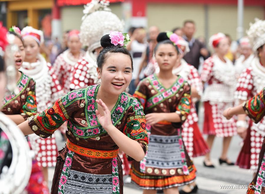 Women in traditional costumes attend a parade during the Yang'esha Cultural Festival in Jianhe County, southwest China's Guizhou Province, July 21, 2015. 