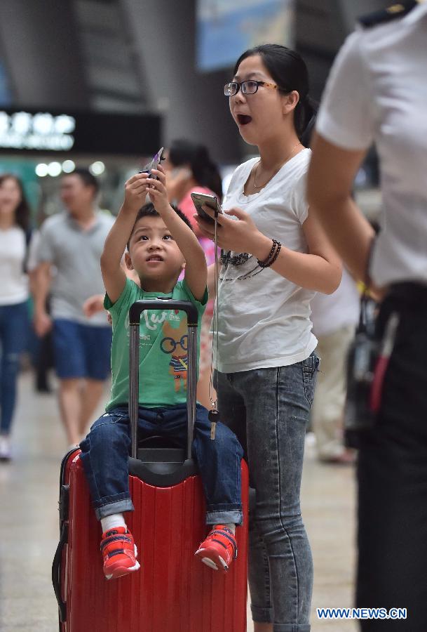 Passengers wait for boarding train at Beijing South Railway Station in Beijing, July 24, 2015. 