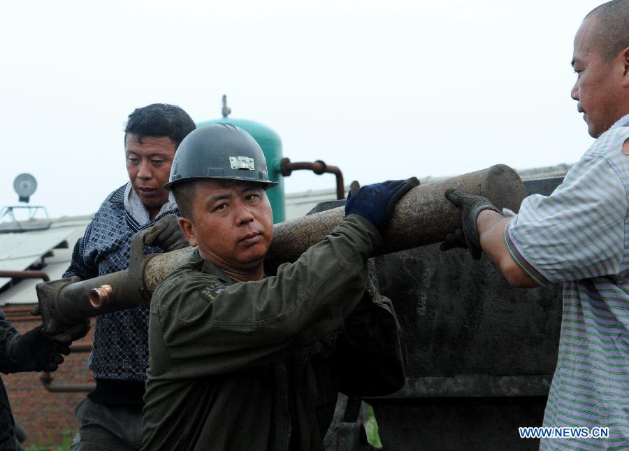 Rescuers load rescue materials onto a tramcar at Xuxiang Colliery in Hegang City, northeast China's Heilongjiang Province, July 24, 2015. 