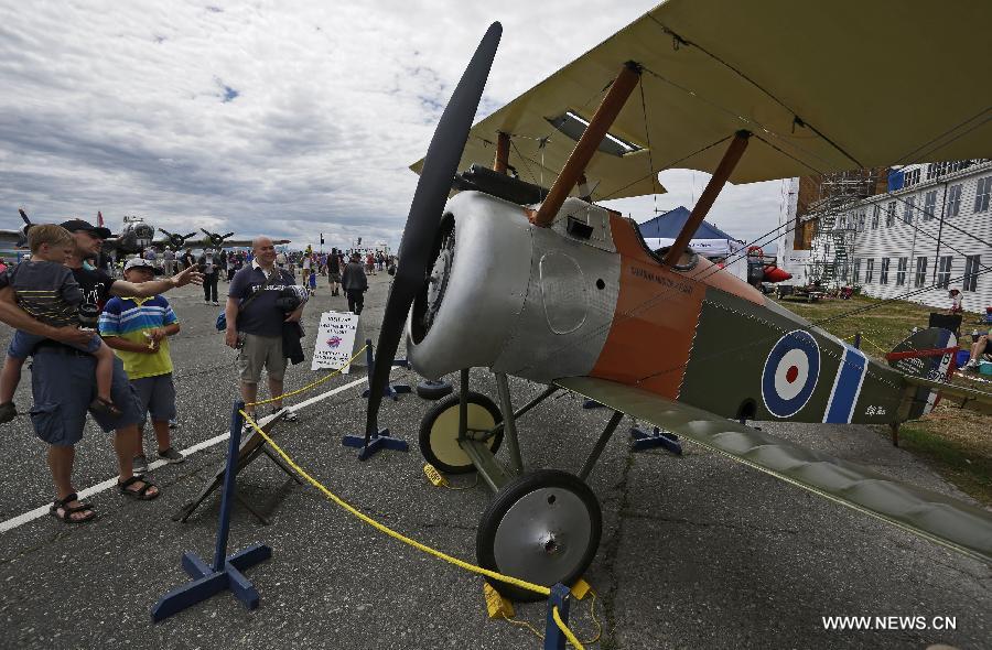 Visitors watch a vintage aircraft on display at the Boundary Bay air show in Delta, Canada, July 25, 2015. 