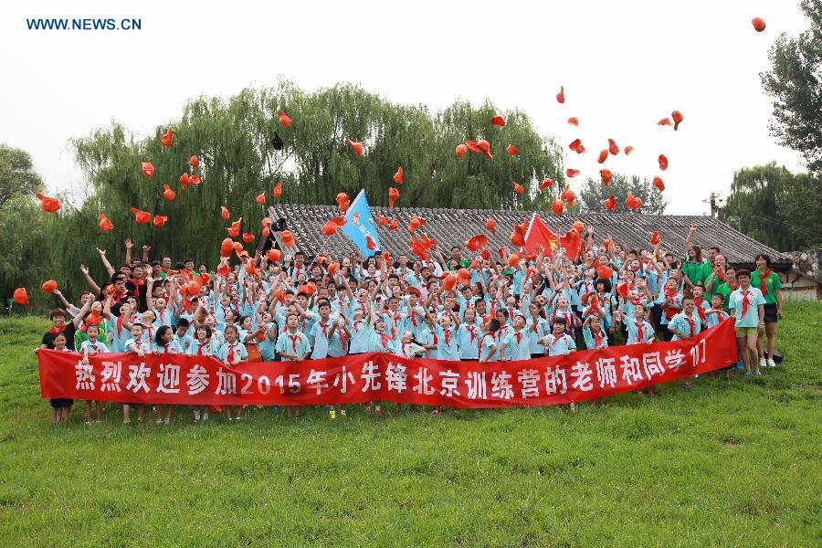 Campers pose for photo during a opening ceremony for a summer camp in Beijing, capital of China, July 27, 2015. 