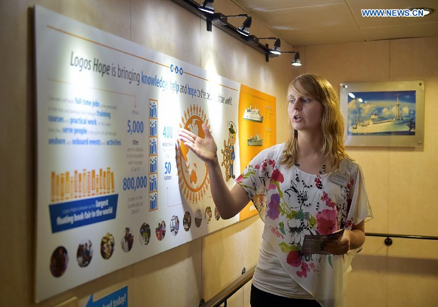 An exbihitor introduces the book fair at Logos Hope in south China's Hong Kong, July 27, 2015.