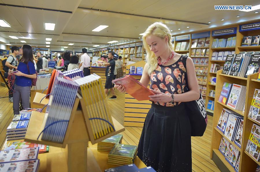 A visitor selects books at the book fair of Logos Hope in south China's Hong Kong, July 27, 2015.