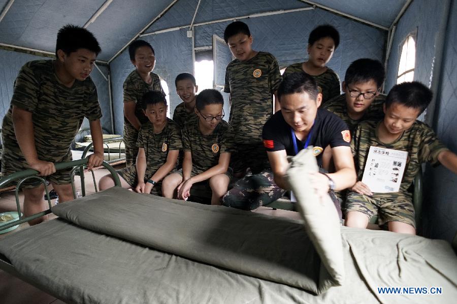 Students participate in a military summer camp in Beijing, capital of China, July 29, 2015. The military summer camp for youths, located in the Daxing District of Beijing, has attracted more than 15,000 students from across the country since 2008, when it was opened. (Xinhua/Li Xin) 