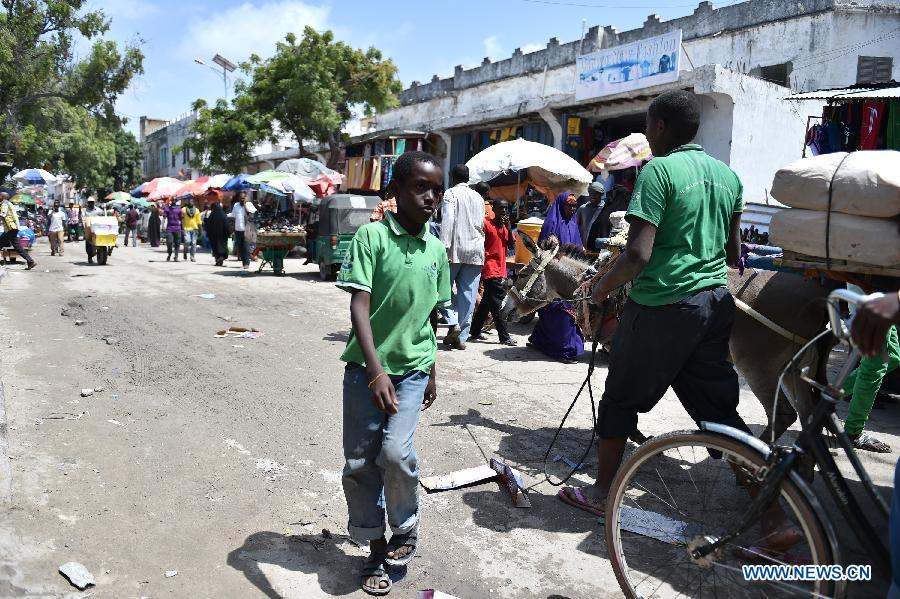 A boy walks inside a market area in Mogadishu, Somalia, July 30, 2015.