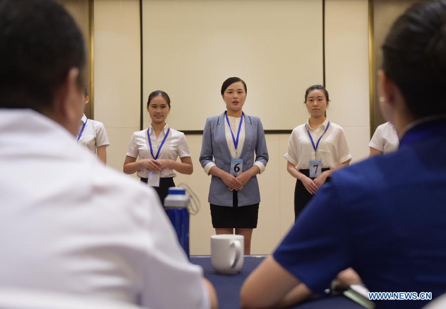 Candidates for flight attendant of China Southern Airlines wait to take part in the first round interview in Wuhan, capital of central China's Hubei Province, July 30, 2015. China Southern Airlines has extended the requirement of age for flight attendants to 30. (Xinhua/Cheng Min) 