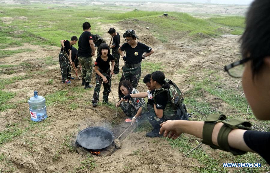 Students participate in a military summer camp in Beijing, capital of China, July 29, 2015. The military summer camp for youths, located in the Daxing District of Beijing, has attracted more than 15,000 students from across the country since 2008, when it was opened. (Xinhua/Li Xin) 