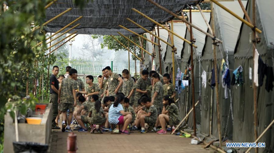 Students participate in a military summer camp in Beijing, capital of China, July 29, 2015. The military summer camp for youths, located in the Daxing District of Beijing, has attracted more than 15,000 students from across the country since 2008, when it was opened. (Xinhua/Li Xin) 