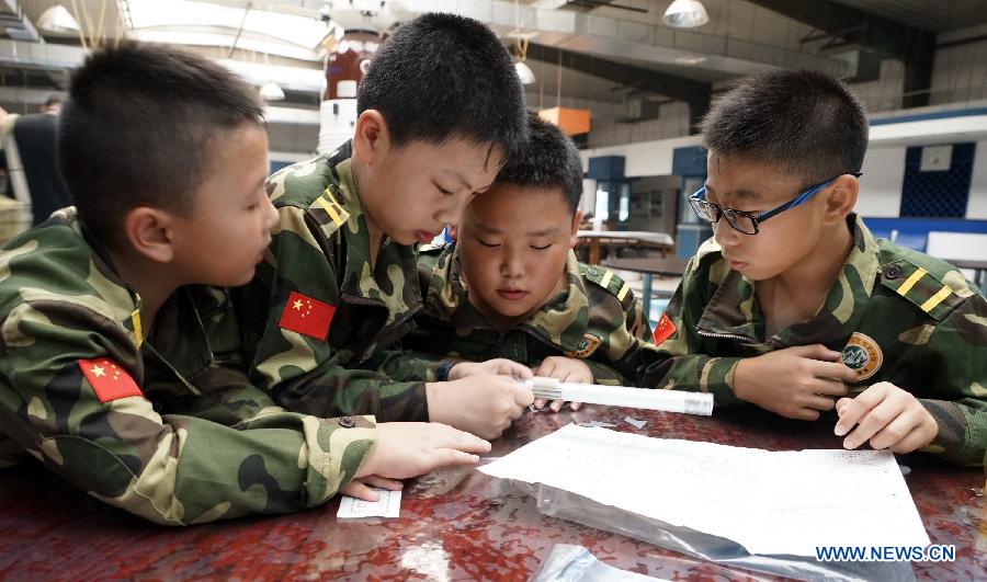 Students participate in a military summer camp in Beijing, capital of China, July 29, 2015. The military summer camp for youths, located in the Daxing District of Beijing, has attracted more than 15,000 students from across the country since 2008, when it was opened. (Xinhua/Li Xin) 