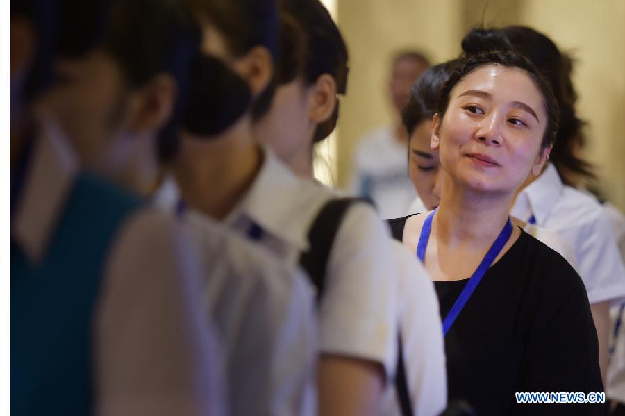 Candidates for flight attendant of China Southern Airlines wait to take part in the first round interview in Wuhan, capital of central China's Hubei Province, July 30, 2015. China Southern Airlines has extended the requirement of age for flight attendants to 30. (Xinhua/Cheng Min) 