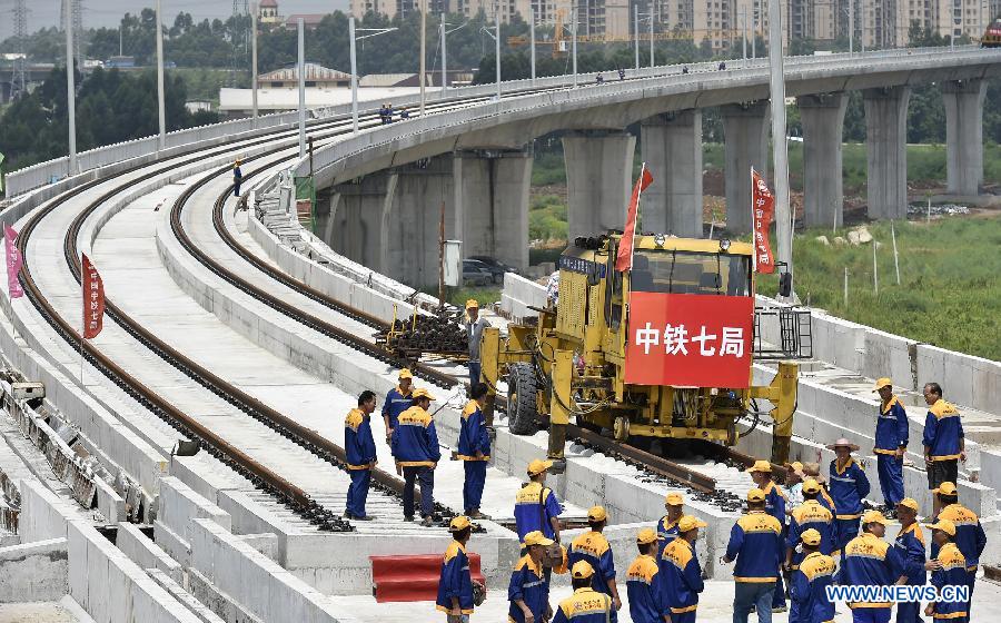 Workers celebrate the completion of track laying operation of Foshan-Zhaoqing intercity rail line, south China's Guangdong Province, July 31, 2015. Ballastless track laying of the 79.717-kilometer-long rail line was finished on Friday. (Xinhua/Liang Xu) 