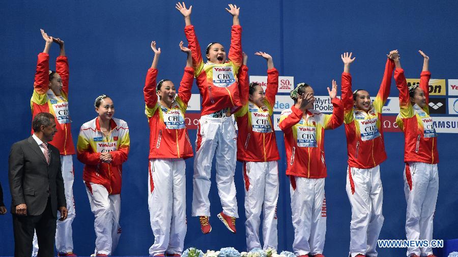 Team China celebrates on the podium during the awarding ceremony for team free of the synchonised swimming at the FINA World Championships in Kazan, Russia, July 30, 2015.