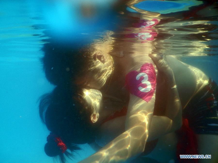 Participants take part in an underwater kissing contest in Wuhan, capital of central China's Hubei Province, Aug. 2, 2015.