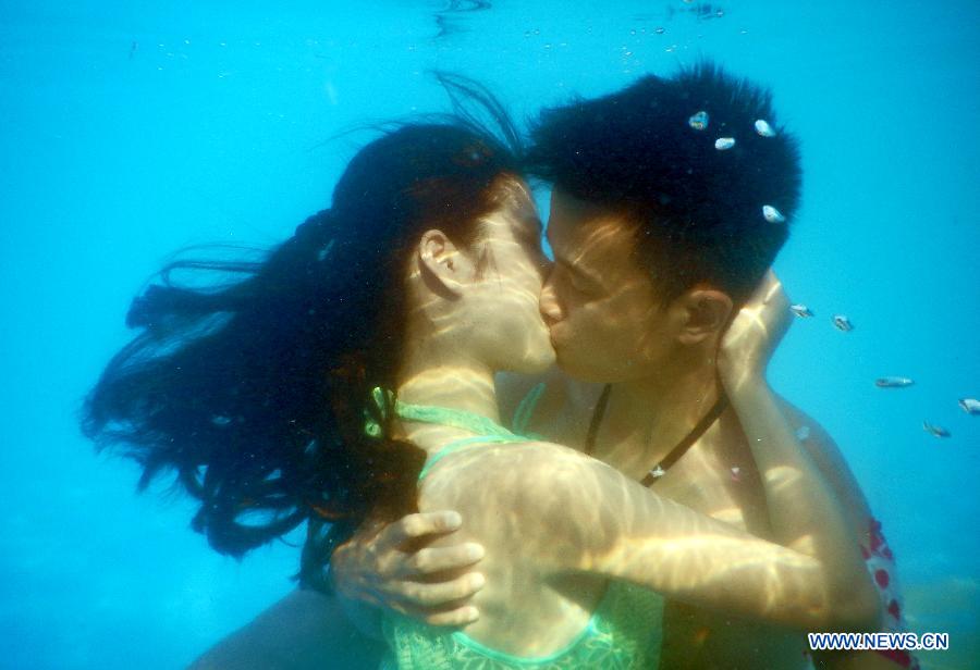 Participants take part in an underwater kissing contest in Wuhan, capital of central China's Hubei Province, Aug. 2, 2015. 