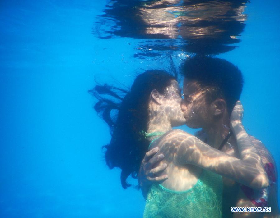 Participants take part in an underwater kissing contest in Wuhan, capital of central China's Hubei Province, Aug. 2, 2015.