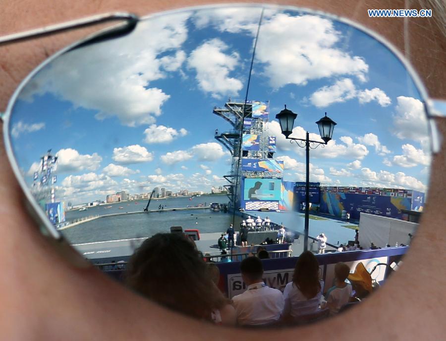 High diving venue is seen reflected in spectator's sunglasses during men's high dive preliminaries at FINA World Championships in Kazan, Russia, Aug. 3, 2015.