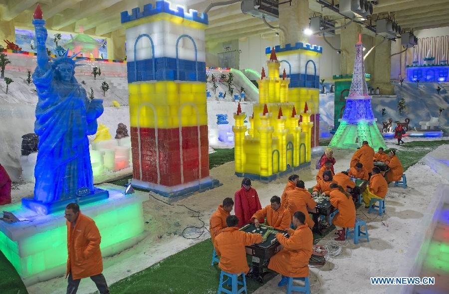 People wearing padded coats play mahjong in an icehouse at Foreigner's Street in Chongqing, southwest China, Aug. 4, 2015.