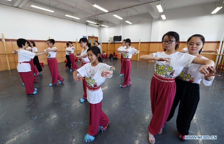 Teachers teach the youngsters the basic movements in traditional Chinese opera in National Academy of Chinese Theatre Arts in Beijing, capital of China, Aug. 4, 2015.