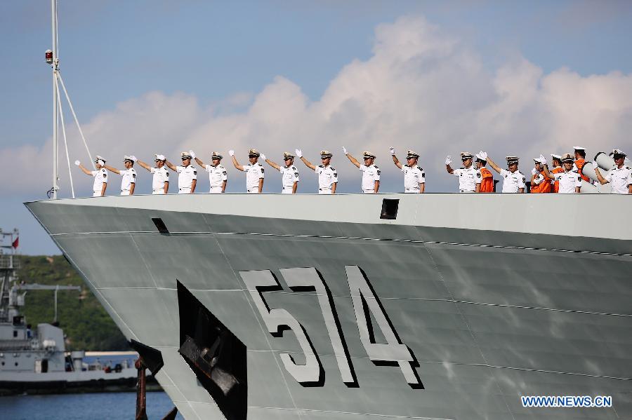 Chinese Navy soldiers wave farewell at a naval port in Sanya, south China's Hainan Province, Agu. 4, 2015. 