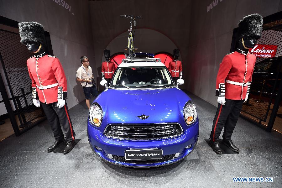 A visitor views a car on display during Taiyuan International Auto Show at Coal Transaction Center in Taiyuan, capital of China's north Shanxi province Aug. 6, 2015.