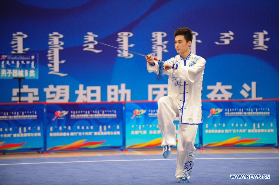 Lyu Taidong from northwest China's Gansu Province competes in a men's game of martial arts of the ethnic minorities during the 10th National Traditional Games of Ethnic Minorities of China in Ordos, north China's Inner Mongolia Autonomous Region, Aug. 10, 2015.