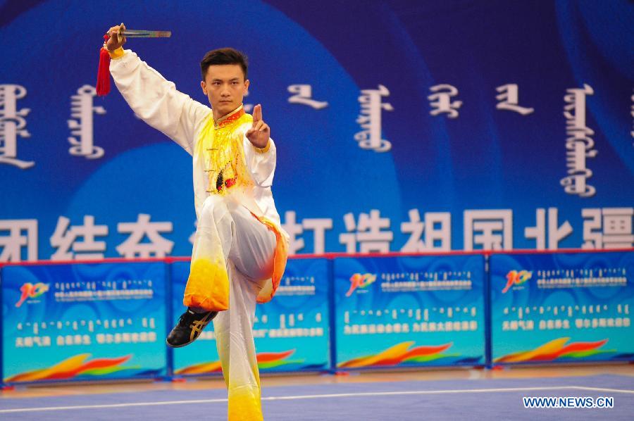 Wu Yanan from northwest China's Shaanxi Province competes in a men's game of martial arts of the ethnic minorities during the 10th National Traditional Games of Ethnic Minorities of China in Ordos, north China's Inner Mongolia Autonomous Region, Aug. 10, 2015. 