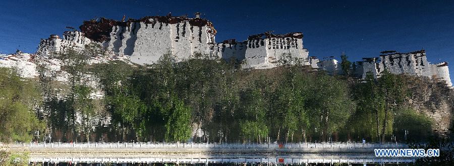 Photo taken on May 14, 2014 shows the reflection of the Potala Palace over the surface of a lake in Lhasa, capital of southwest China's Tibet Autonomous Region.