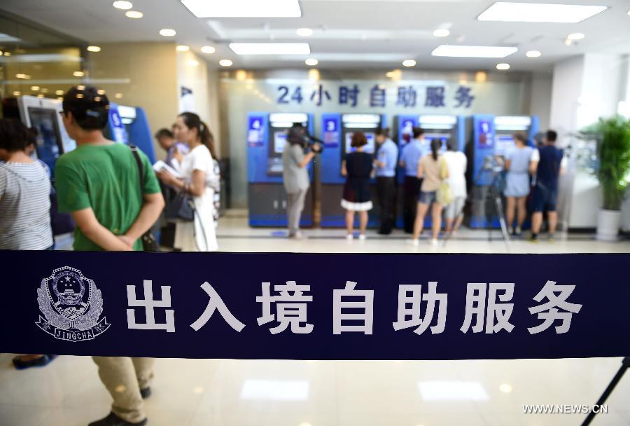 People use self-service equipments for passengers's entry and exit at the Shenyang Immigration Inspection hall in Shenyang, capital of northeast China's Liaoning Province, Aug. 14, 2015.