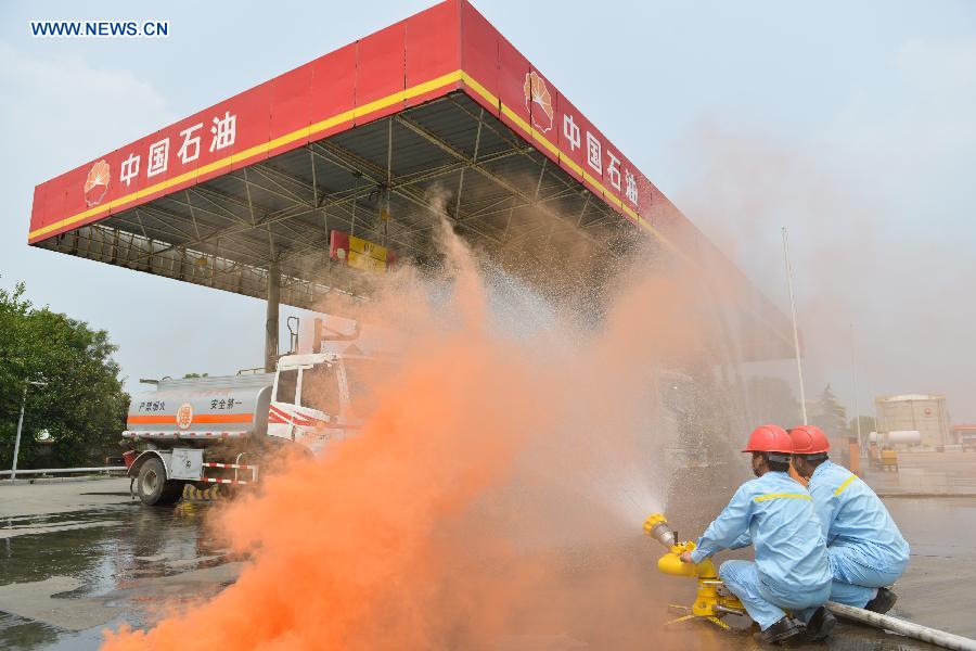 A fire drill is held at an oil depot in Daxing Town of Hefei, capital of east China's Anhui Province, Aug. 17, 2015. 