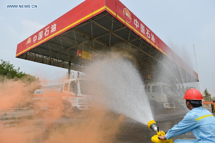 A fire drill is held at an oil depot in Daxing Town of Hefei, capital of east China's Anhui Province, Aug. 17, 2015. 