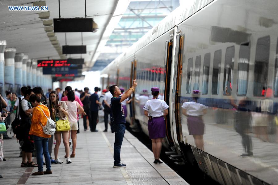 The high-speed train D7989 prepares to depart for Qiqihar at the Harbin Railway Station in Harbin, capital of northeast China's Heilongjiang Province, Aug. 17, 2015. 