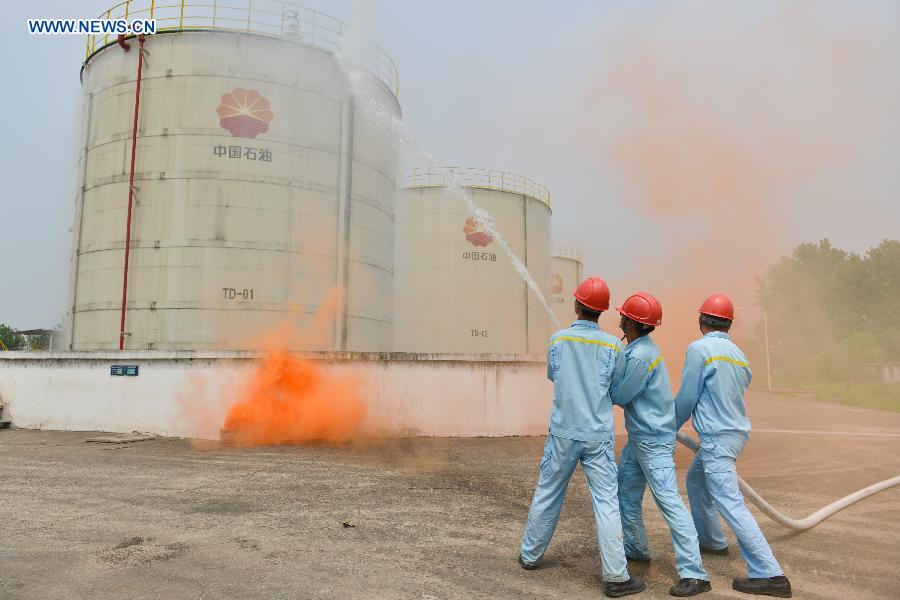 A fire drill is held at an oil depot in Daxing Town of Hefei, capital of east China's Anhui Province, Aug. 17, 2015.