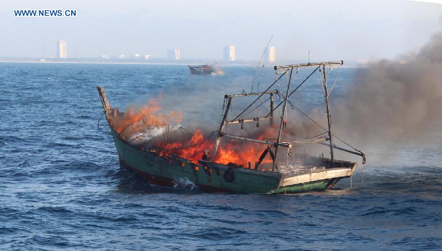 A fishing vessel is on fire as it was sailing six nautical miles off the coast of Wenchang, south China's Hainan Province, Aug. 17, 2015.