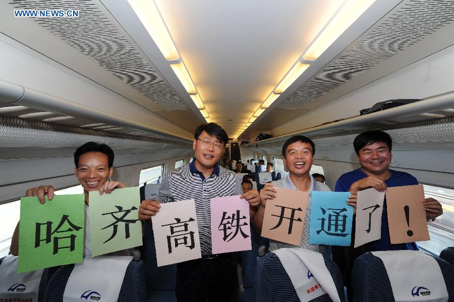 Passengers celebrate on the high-speed train D7989, northeast China's Heilongjiang Province, Aug. 17, 2015.