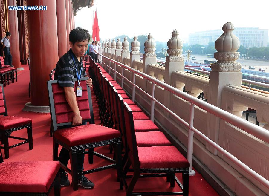 Staff workers put chairs at the Tian'anmen Rostrum in Beijing, capital of China, Aug. 17, 2015.