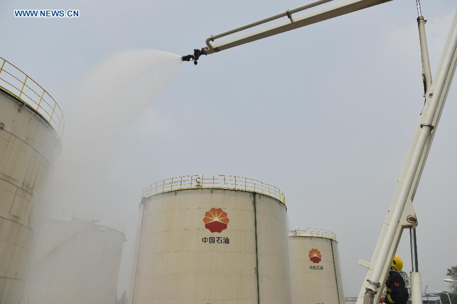 A fire drill is held at an oil depot in Daxing Town of Hefei, capital of east China's Anhui Province, Aug. 17, 2015.