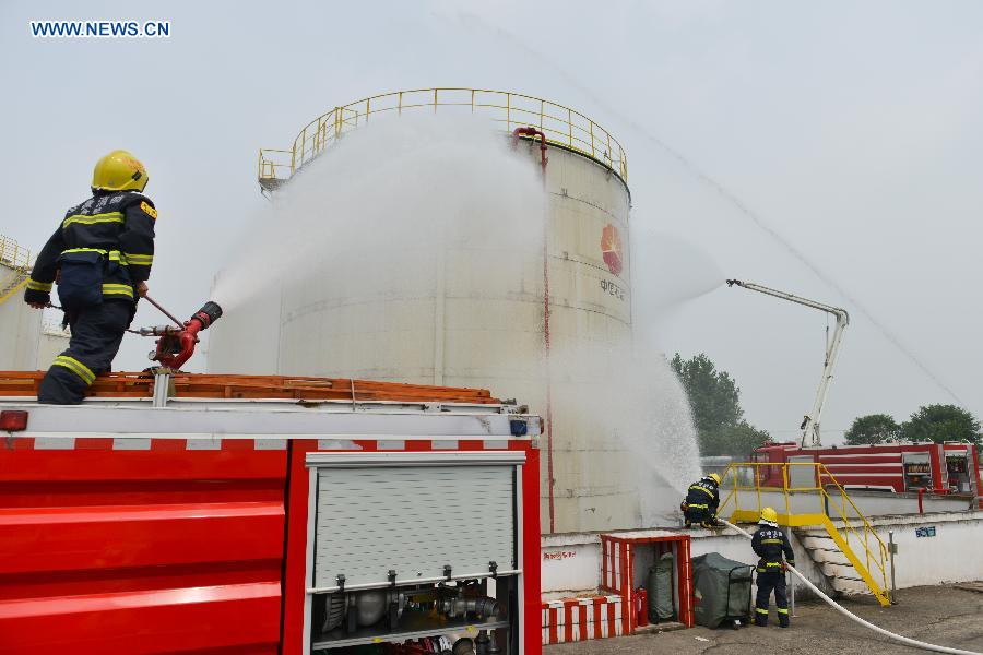 A fire drill is held at an oil depot in Daxing Town of Hefei, capital of east China's Anhui Province, Aug. 17, 2015. 