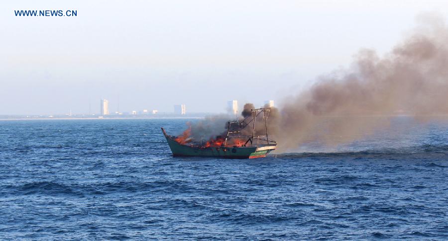 A fishing vessel is on fire as it was sailing six nautical miles off the coast of Wenchang, south China's Hainan Province, Aug. 17, 2015. 