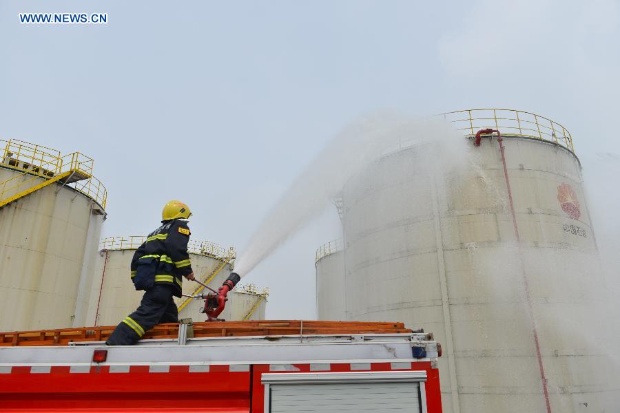 A fire drill is held at an oil depot in Daxing Town of Hefei, capital of east China's Anhui Province, Aug. 17, 2015. 