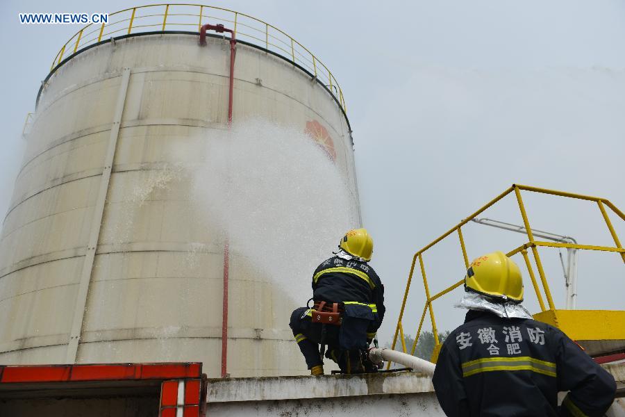 A fire drill is held at an oil depot in Daxing Town of Hefei, capital of east China's Anhui Province, Aug. 17, 2015. 