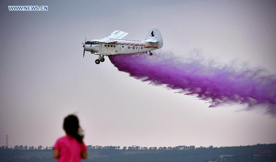 An aircraft shows aerobatics at the opening ceremony of the 2015 Shenyang Faku International Flight Convention, in Faku County of Shenyang, capital of northeast China's Liaoning Province, Aug. 20, 2015.