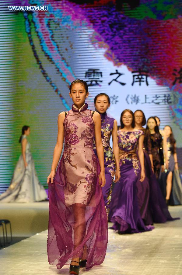 Models present cheongsam, a traditional Chinese women's dress also known as Qipao, during a show in Kunming, southwest China's Yunnan Province, Aug. 21, 2015.