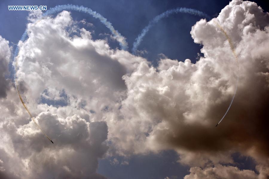 Two aircraft show aerobatics, making a formation in the shape of a heart from a trail of smoke at the 2015 Shenyang Faku International Flight Convention, in Faku County of Shenyang, capital of northeast China's Liaoning Province, Aug. 21, 2015. 