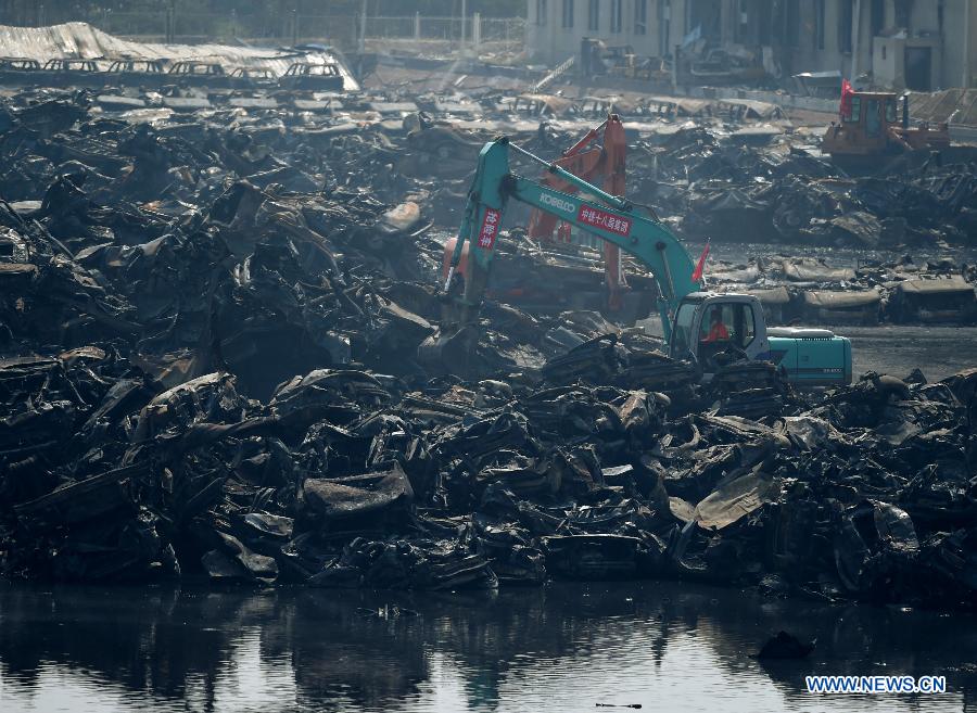 Rescuers clean up the debris at the core blast site in Tianjin, north China, Aug. 22, 2015. 