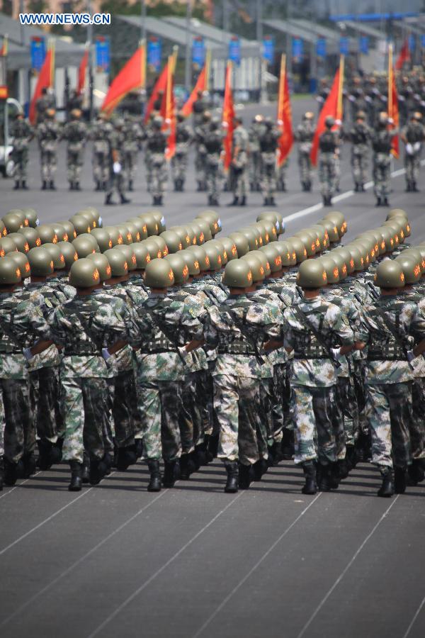 Photo taken on July 24, 2015 shows soldiers participating in training for the Sept. 3 military parade at the parade training base in Beijing.