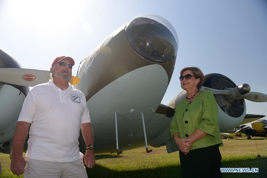 Nell Calloway (R), Chennault Aviation and Military Museum Director and a grand daughter of Flying Tigers commander Lieutenant General Claire Lee Chennault, introduces a B-25 Bomber used by Flying Tigers during an interview with Xinhua News Agency in Monroe, Louisiana, the United States, July 15, 2015. 