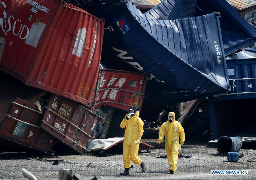 Rescuers clean up the debris at the core blast site in Tianjin, north China, Aug. 22, 2015. 