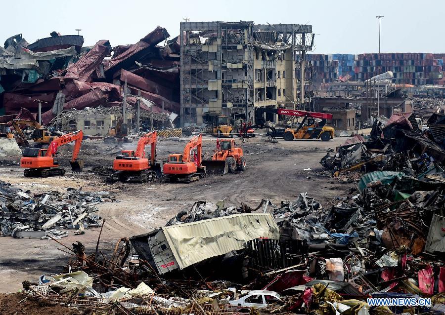 Rescuers work at the core area of explosion site in Tianjin, north China, Aug. 25, 2015.