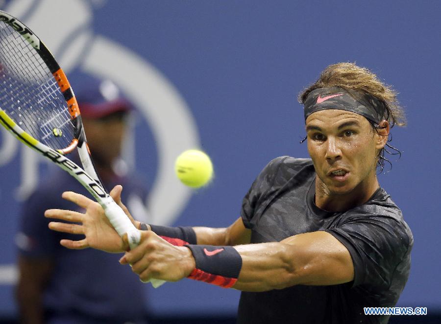 Rafael Nadal of Spain returns a ball to Borna Coric of Croatia during the men's singles first round match at the 2015 U.S. Open in New York, the United States, Aug. 31, 2015.  